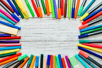 Fototapeta premium Stationery, colored felt-tip pens on a white table.
