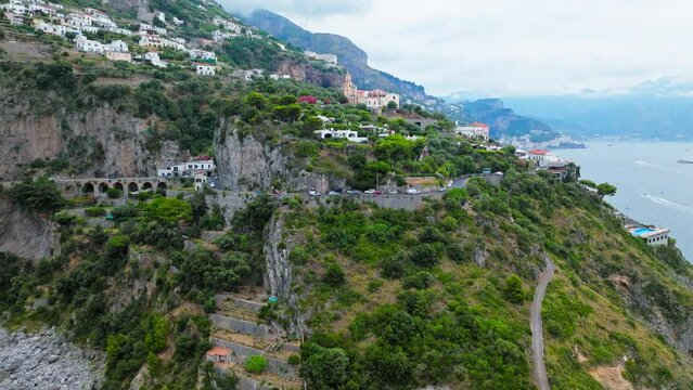 Aerial drone view of Conca dei Marini town on Amalfi Coast in Italy, Europe. Panoramic top view from above of Italian colourful houses, Chiesa San Pancrazio Martire and Torre Capo in ProRes 4K.