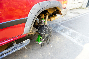 Fototapeta na wymiar Car maintenance expert fixing wheel wrapped in cloth