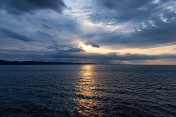 Obraz premium Cloudy Cloudscape during stormy everning on the West Coast of Pacific Ocean. British Columbia, Canada. Sunset Sky