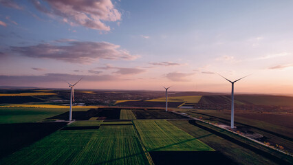 Windmill turbines generating green energy electric.Green energy helps reduce carbon emissions and...