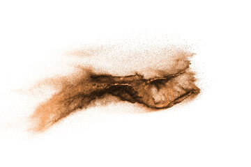 Golden sand explosion isolated on white background. Abstract sand cloud.Sandy fly wave in the air.