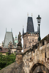 Fototapeta na wymiar Vertical view of the famous Charles bridge in Prague against a cloudy sky.