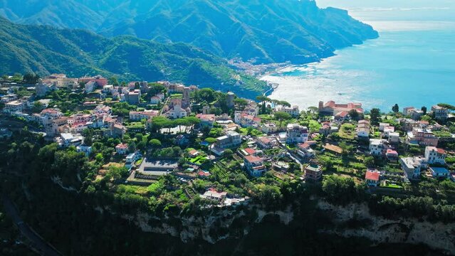 Aerial drone view of Ravello resort town with iconic cliffside gardens, Italy. Top view from above of Duomo di Ravello, famous Villa Rufolo hosting concerts and Festivals on the Amalfi Coast in Europe