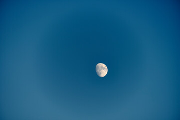 An almost full moon on a blue background