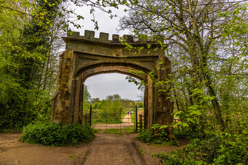 Fototapeta na wymiar A view from Badby Wood out through the entrance structure in Northamptonshire, UK in summertime