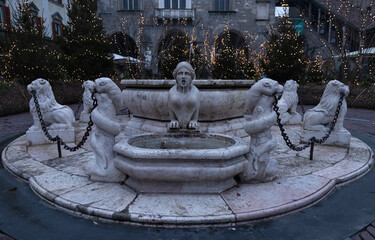 Fountain in Piazza Vecchia in Bergamo in Italy.
With Christmas lights in the background.