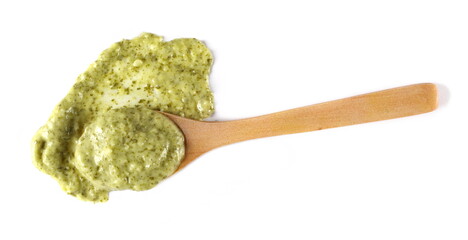 Green mojo sauce, mojo verde, spilled in wooden spoon isolated on white, clipping path  - obrazy, fototapety, plakaty
