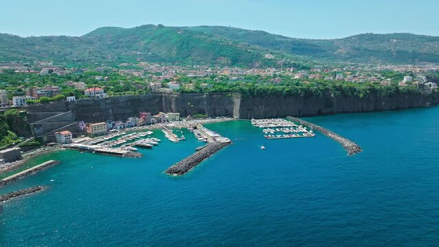 Aerial drone view of coastal Port and Villa Fondi De Sangro in Sant'Agnello. Scenic Amalfi Coast view with boats and ships parked in a harbour in Italy.