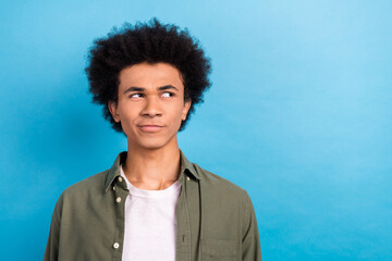 Portrait of young handsome thinking guy funny chevelure wear khaki shirt look novelty distrust...