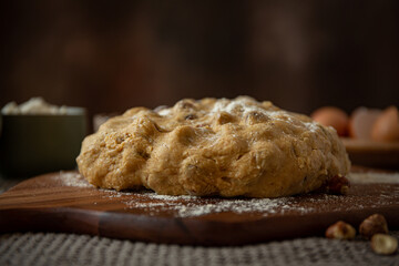 Dough for Italian biscotti with hazelnut, eggs, flour on wooden board 