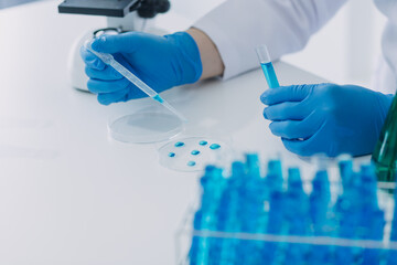 hand of scientist with test tube and flask in medical chemistry lab blue banner background