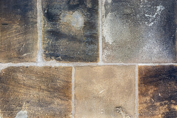Fragment of a wall made of rough-hewn stone blocks for use as an abstract background and texture.