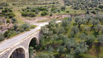 Tatar Bridge - Very old stone arch bridge from Ottoman or even older times about 30 m long with three arches, 2 central piers, completely preserved near Urla, Turkish Aegean Sea
