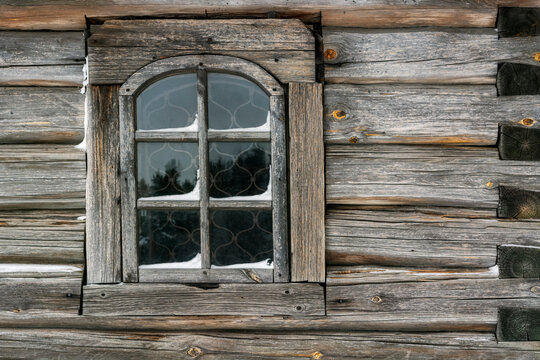 Old rectangular window with a wooden frame in an old log house. From the Window of the World series.