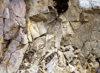 the wall is made of natural material, the stone is a limestone material of volcanic origin, close-up.