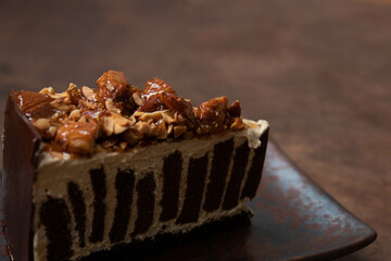 a slice of Almond Chocolate cake on rustic background