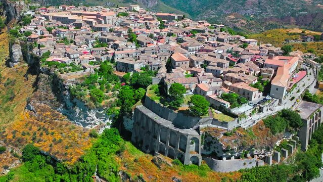  Scenic aerial view of a medieval urban village on a hill in Gerace, Italy. View from above over red rooftops in Calabria. 