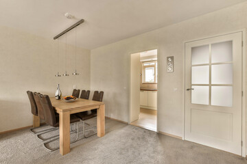 a dining room with a table and chairs on the floor in front of an open door that leads to another room
