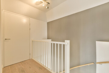 an empty room with wood flooring and white railings on the staircase leading up to the second floor...