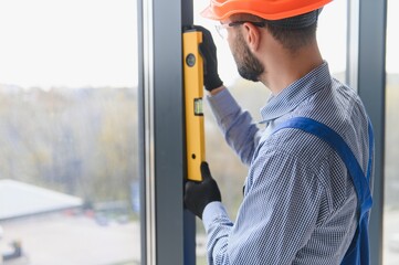 service man installing plastic window.