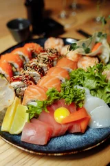 Foto op Plexiglas Mixed Sushi Set nigiri, rolls and sashimi served in traditional Japan black Sushioke round plate. © Дмитрий Скорина
