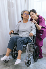 Caregiver nurse take care a Senior patient walking in park. Nurse helping senior Woman