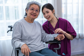 Obraz premium Caregiver nurse take care a Senior patient walking in park. Nurse helping senior Woman