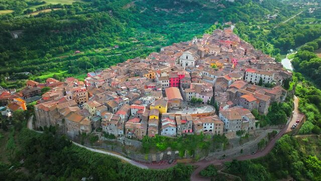 Aerial footage over the rooftops of colourful stone houses in Orte, Italy. View from above over the Catholic bishopric and Latin titular see in the province of Viterbo, in the central Italian region o