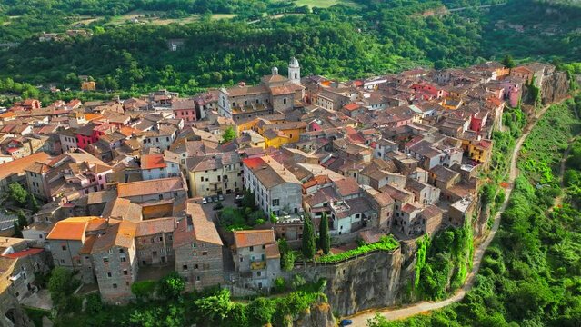 Aerial footage over the rooftops of colourful stone houses in Orte, Italy. View from above over the Catholic bishopric and Latin titular see in the province of Viterbo, in the central Italian region o