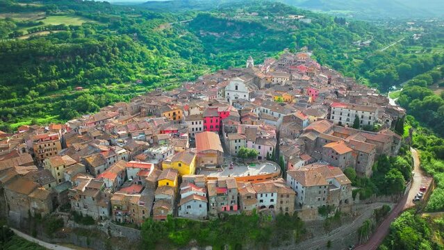 Aerial footage over the rooftops of colourful stone houses in Orte, Italy. View from above over the Catholic bishopric and Latin titular see in the province of Viterbo, in the central Italian region o