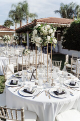 wedding arch for an outdoor wedding ceremony on a green lawn, decorated with white flowers