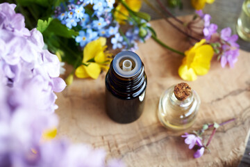 Dropper bottle of essential oil with colorful flowers