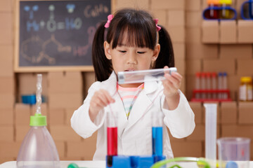 young girl plays  science experiment for home schooling