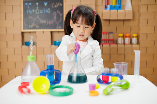 young girl plays  science experiment for home schooling
