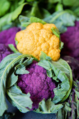 Colorful yellow and purple cauliflowers in natura on a gray surface © Luca