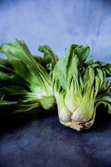 Bok choy in natura on a gray surface. © Luca