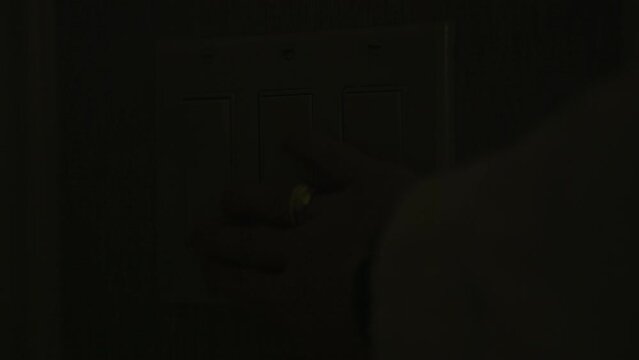 Close up view of Person turns light switch on and off. Hand, finger. Hotel, trip. Light is Off - Female hand switch off a button on a light. High Quality 4k footage.