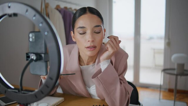 Influencer making makeup review smartphone camera closeup. Lady learning online