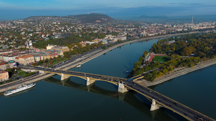 Fototapeta premium Establishing Aerial View Shot of Budapest, Hungary at sunrise. Margaret Bridge or Margit hid over River Danube, embankment
