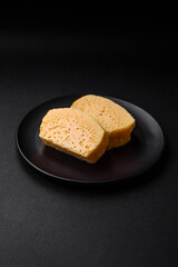 Delicious porous yellow cheese cut in large pieces on a ceramic plate