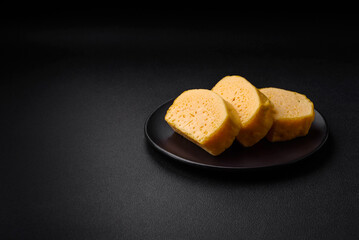 Delicious porous yellow cheese cut in large pieces on a ceramic plate