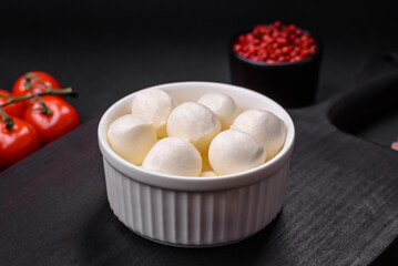 Delicious fresh mozzarella cheese in the form of small balls with salt and spices
