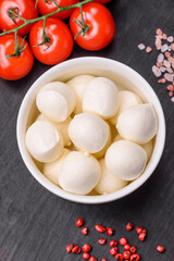 Delicious fresh mozzarella cheese in the form of small balls with salt and spices