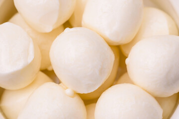 Fototapeta na wymiar Delicious fresh mozzarella cheese in the form of small balls with salt and spices