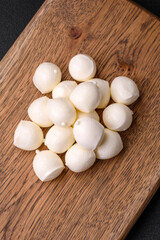 Delicious fresh mozzarella cheese in the form of small balls with salt and spices