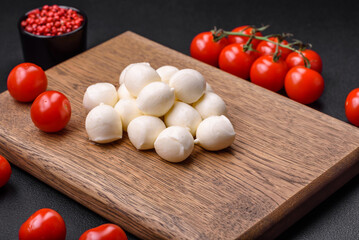 Delicious fresh mozzarella cheese in the form of small balls with salt and spices