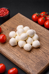 Delicious fresh mozzarella cheese in the form of small balls with salt and spices