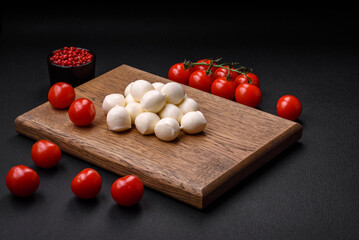 Delicious fresh mozzarella cheese in the form of small balls with salt and spices