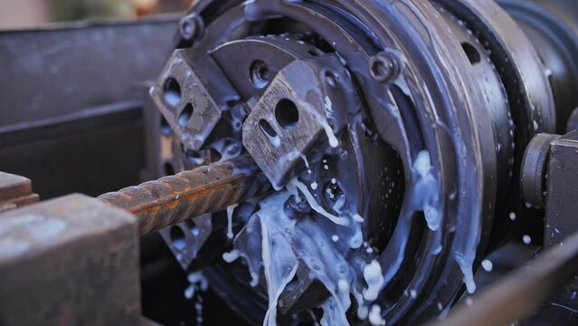 Construction machine for threading fittings on rebar